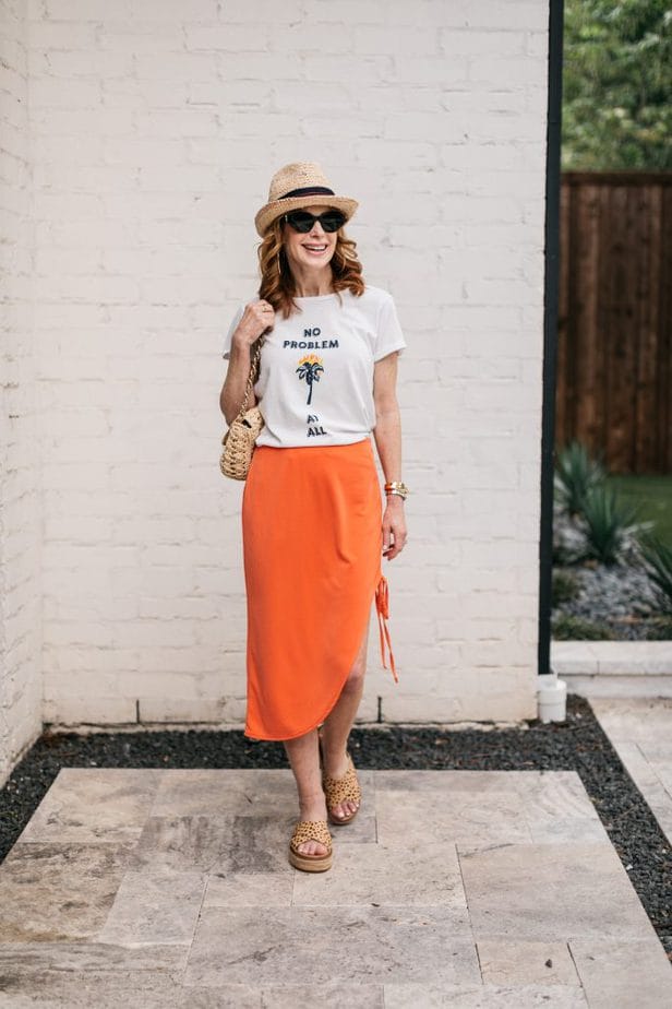 woman wearing orange skirt and white shirt