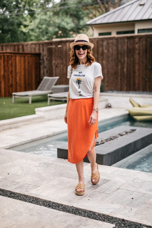 woman standing near the pool and happy as It's Still Summer