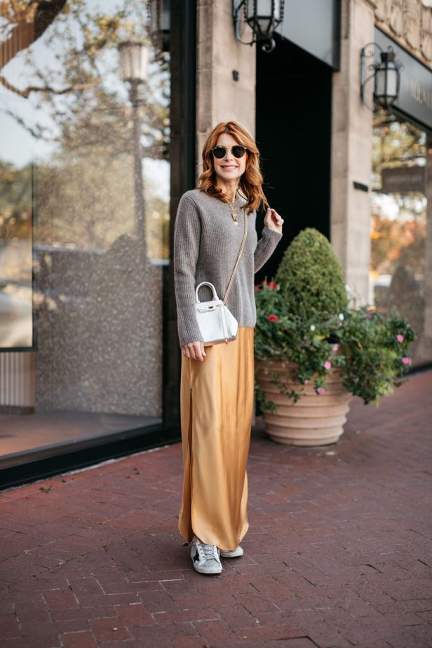 woman wearing cashmere sweater, silk dress. white shoes, sunglasses, and bag from Cyber Monday sale 
