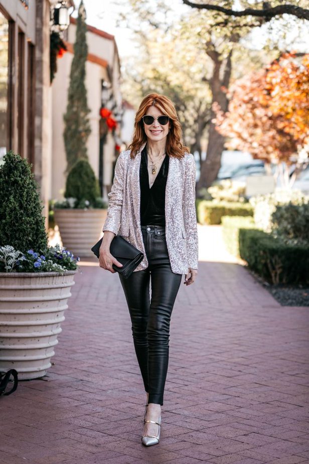 woman in black top, glitter blazer, and leather bottoms 