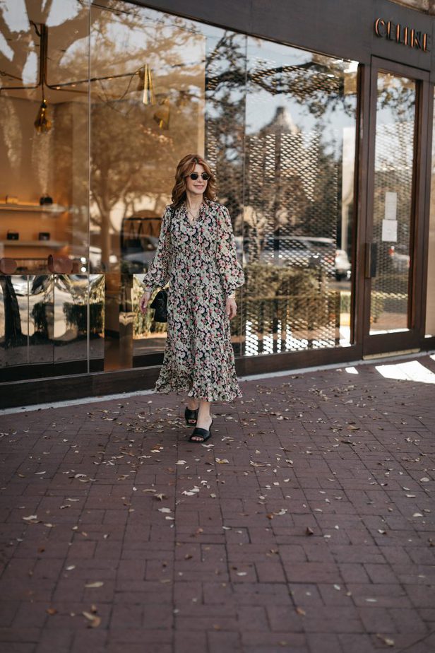 woman in a Sophisticated Floral Dress outside a store