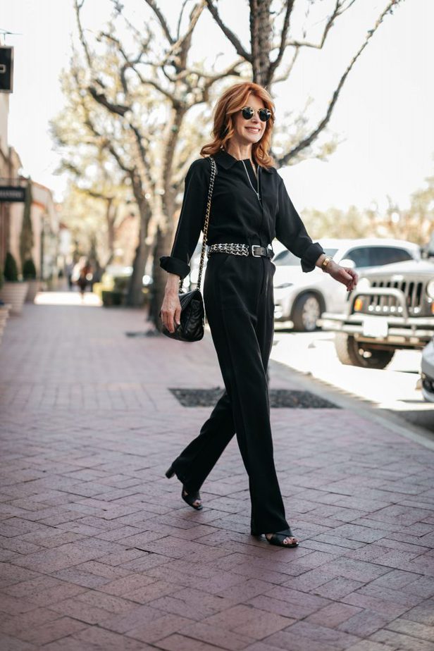 woman walking and wearing BLACK JUMPSUIT 