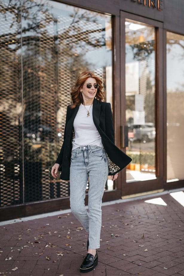 woman walking in white shirt, blazer, and jeans 