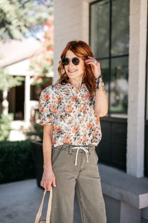 woman in floral puff sleeve top and her favorite summer denim pants 