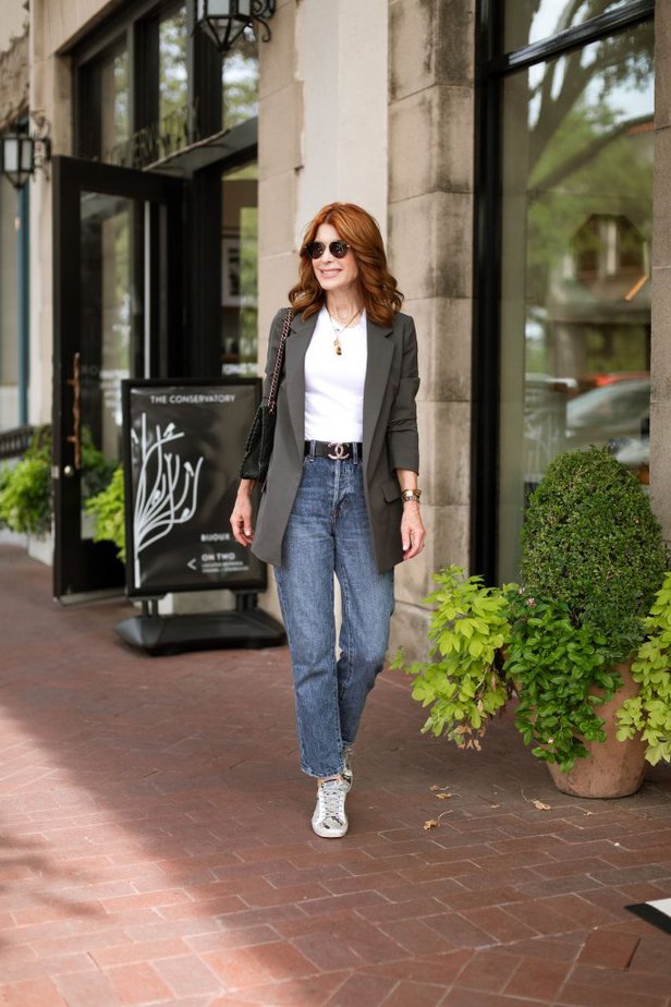 woman wear white tank top, blazer, and denim jeans